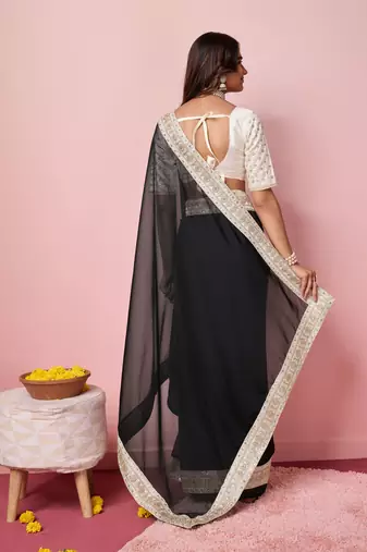 Girlie black organza saree with ethnic embroidery work on border and blouse