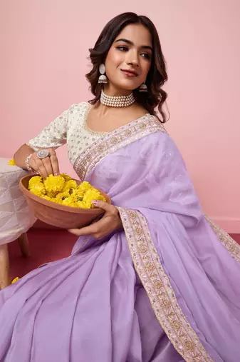 Girlie purple organza saree with ethnic embroidery work on border and blouse