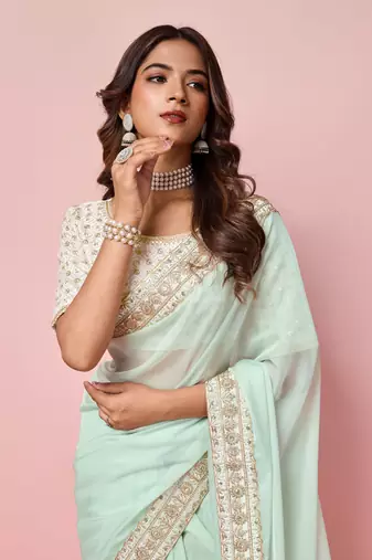 Girlie sea green organza saree with ethnic embroidery work on border and blouse