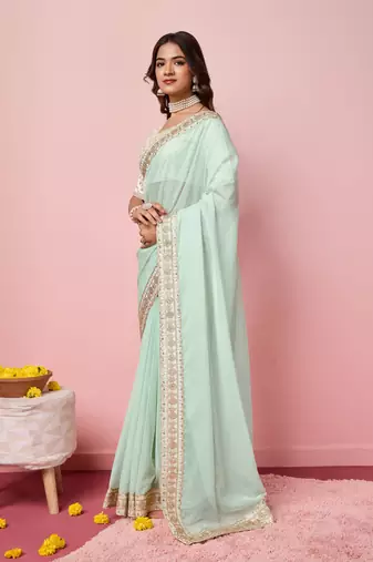 Girlie sea green organza saree with ethnic embroidery work on border and blouse