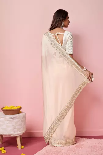 Girlie peach organza saree with ethnic embroidery work on border and blouse