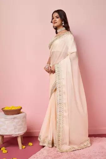 Girlie peach organza saree with ethnic embroidery work on border and blouse