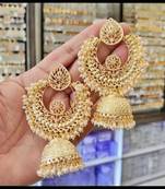 Luxurious gold-plated filigree jhumka earrings with pearl embellishments