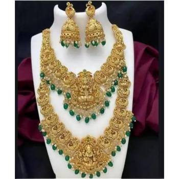 Opulent gold-plated temple jewelry set with emerald accents - bridal necklace, long chain, and jhumka earrings 1
