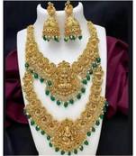 Opulent gold-plated temple jewelry set with emerald accents - bridal necklace, long chain, and jhumka earrings