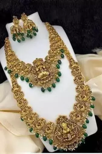 Opulent gold-plated temple jewelry set with emerald accents - bridal necklace, long chain, and jhumka earrings