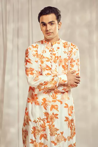 Burnt orange cutdana embroidered silk print kurta.