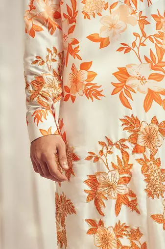 Burnt orange cutdana embroidered silk print kurta.