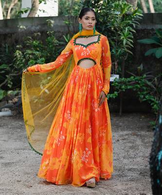 Yellow orange embroidered anarkali with green work and cut-out on the waist in the front and embroidered net dupatta. 1