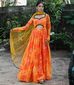 Yellow orange embroidered anarkali with green work and cut-out on the waist in the front and embroidered net dupatta.