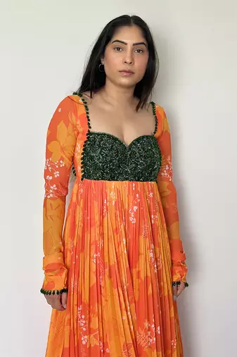 Yellow orange embroidered anarkali with green work and scallop embroidered net dupatta.