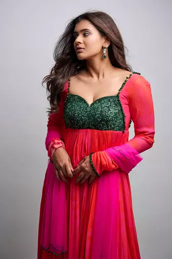 Pink red embroidered anarkali with green work and scallop embroidered net dupatta.