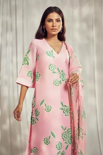 Baby pink print kurti set paired with matching bottom and star organdie dupatta with gold trimming lace detailing.