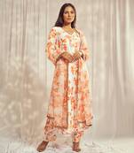 Burnt orange print kurti set paired with matching bottom and star organdie dupatta with gold trimming lace detailing.