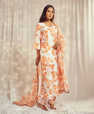 Burnt orange print kurti set paired with matching bottom and star organdie dupatta with gold trimming lace detailing. 2