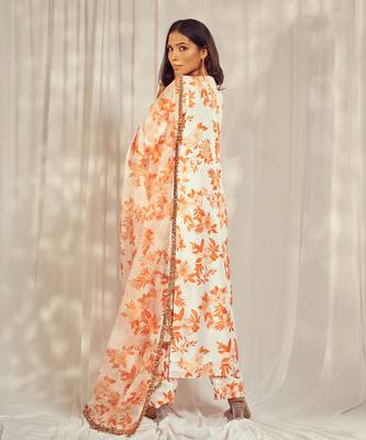 Burnt orange print kurti set paired with matching bottom and star organdie dupatta with gold trimming lace detailing. 4