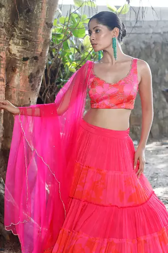 Pink and orange embroidered blouse with matching tiered lehenga