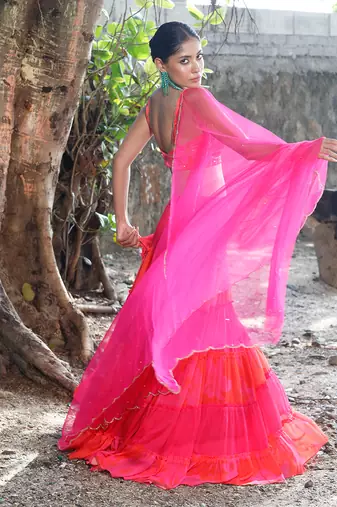 Pink and orange embroidered blouse with matching tiered lehenga