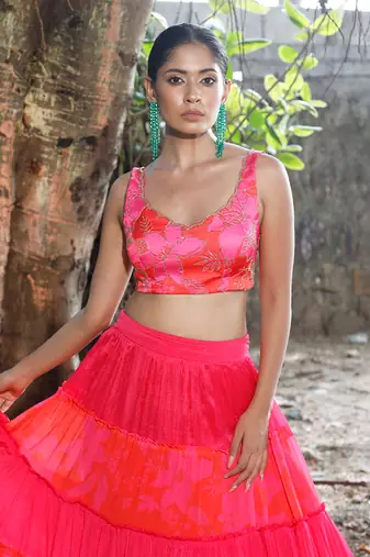 Pink and orange embroidered blouse with matching tiered lehenga