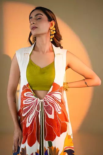 Off-white sleeveless kurta set with floral embroidery & green flared pants