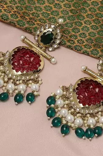 Elegant kundan-inspired chandelier earrings with red and green gemstones
