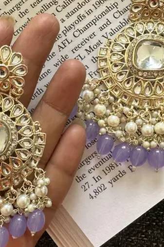 Exquisite kundan-inspired chandelier earrings with pearl and purple accents