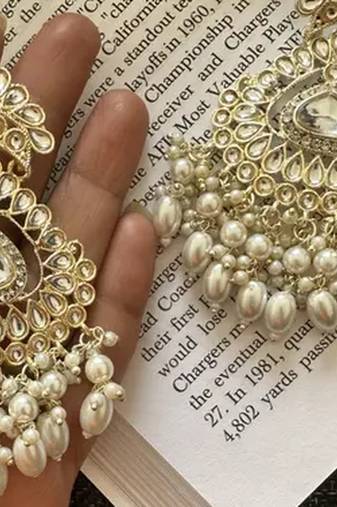 Exquisite kundan-inspired chandelier earrings with pearl and white accents