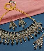 Black kundan choker necklace set with matching earrings and maang tikka