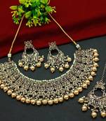Exquisite gold tone and gold kundan jewelry set with pearl accents