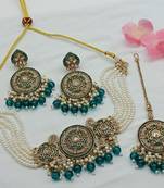 Elegant kundan meena pearl jewelry set with necklace, earrings, and maang tikka