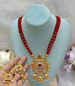 Elegant red pearl and gold kundan necklace set with ornate pendant