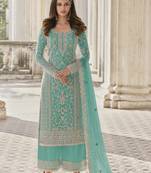Turquoise embroidered net semi stitched straight palazzo suit.