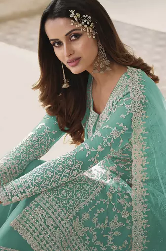 Turquoise embroidered net semi stitched straight palazzo suit.