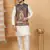 Silk blend cream kurta and churidar with paisley printed navy blue nehru jacket