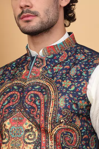 Silk blend cream kurta and churidar with paisley printed navy blue nehru jacket