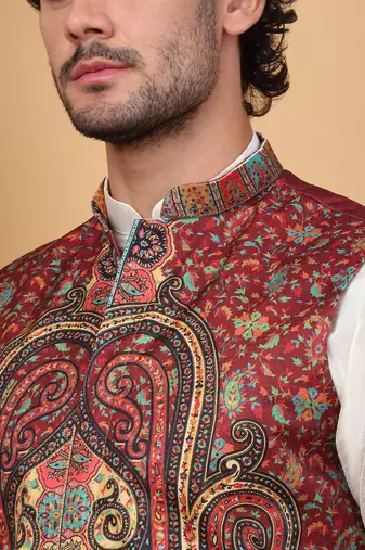 Silk blend cream kurta and churidar with paisley printed maroon nehru jacket