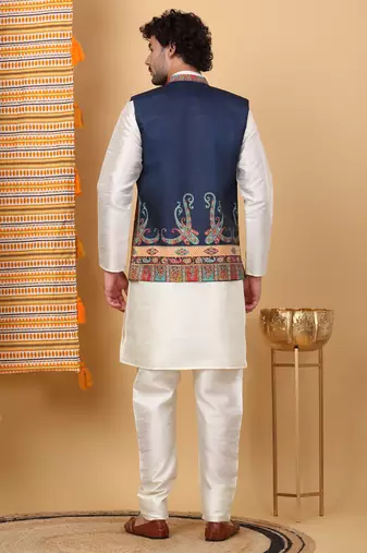 Silk blend cream kurta and churidar with paisley printed navy blue nehru jacket