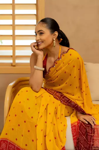 Orange georgette bandhani print plastic mirror work border saree with unstitched blouse piece