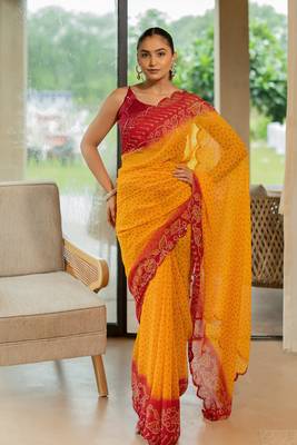 Orange georgette bandhani print stone work border saree with unstitched blouse piece 1