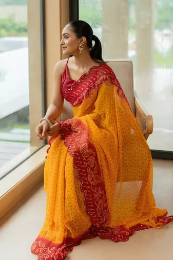 Orange georgette bandhani print stone work border saree with unstitched blouse piece