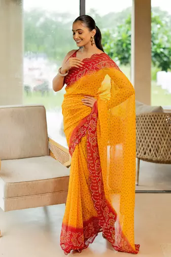 Orange georgette bandhani print stone work border saree with unstitched blouse piece