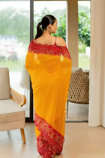 Orange georgette bandhani print stone work border saree with unstitched blouse piece