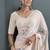 Cream designer hand printed faux georgette saree with blouse piece