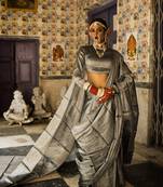 Huts and looms dark grey handloom tissue saree. this saree is 6.5 meters long with 80 cm of blouse piece.