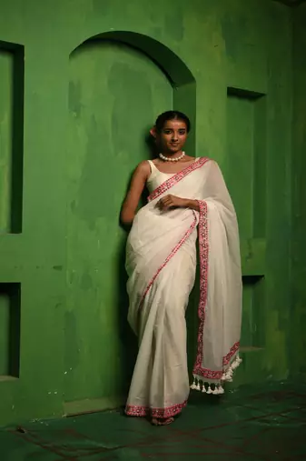 Huts and looms white handloom cotton saree, with an embroidered lace border