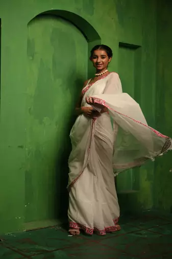 Huts and looms white handloom cotton saree, with an embroidered lace border