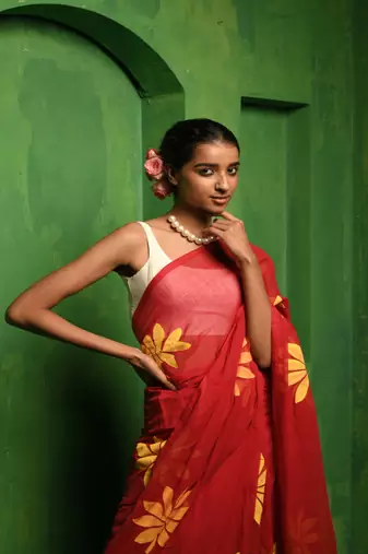 Huts and looms red handloom cotton saree, featuring exquisite hand-painted floral designs throughout the saree.