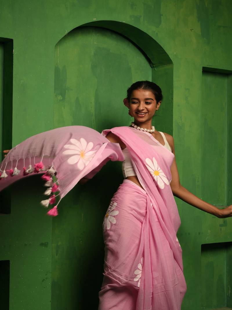 Huts and looms pink handloom cotton saree, featuring exquisite hand-painted floral designs throughout the saree.