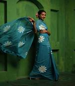 Huts and looms blue handloom cotton saree, featuring exquisite hand-painted floral designs throughout the saree.