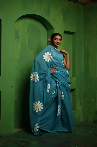 Huts and looms blue handloom cotton saree, featuring exquisite hand-painted floral designs throughout the saree.